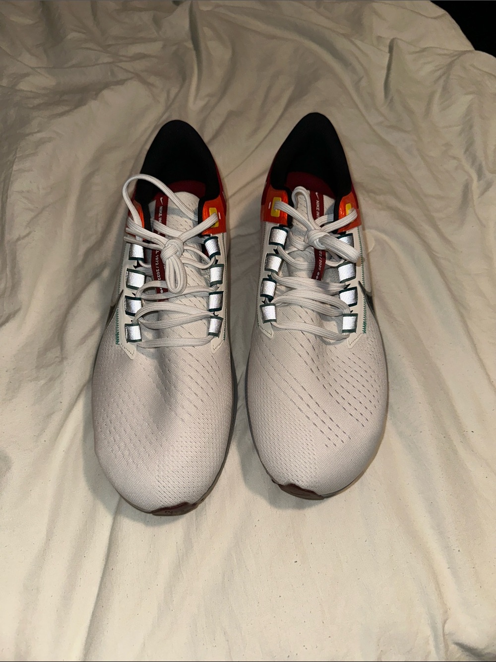 Nike Men's White Running Shoes with Red and Orange Accents